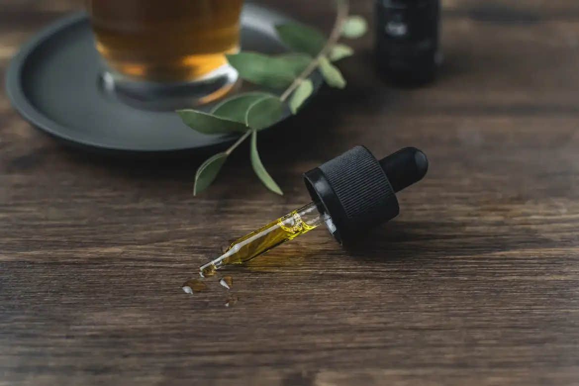 Dropper on table filled with CBD oil for anxiety relief.