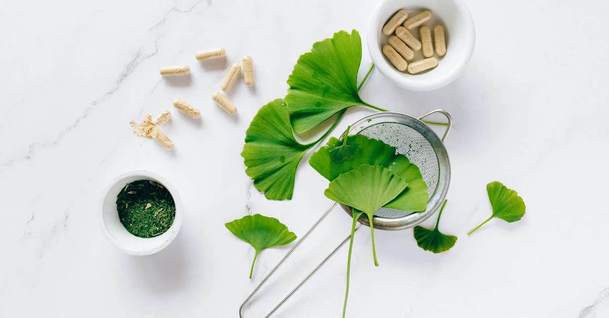 Flat lay of Ashwagandha, capsules, and powdered supplement on a white surface.