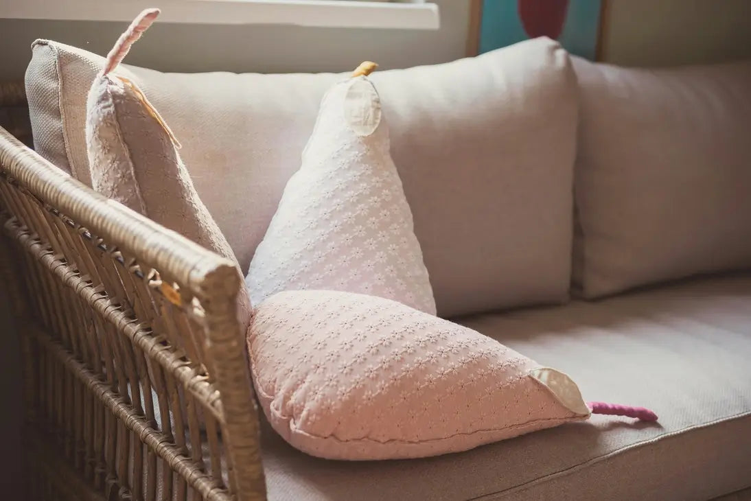 Weighted pillows on a beige couch.