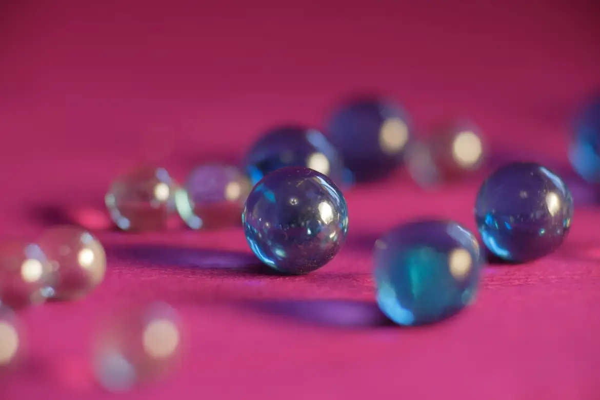 Glass beads used for filling a weighted pillow sitting on a flat surface.