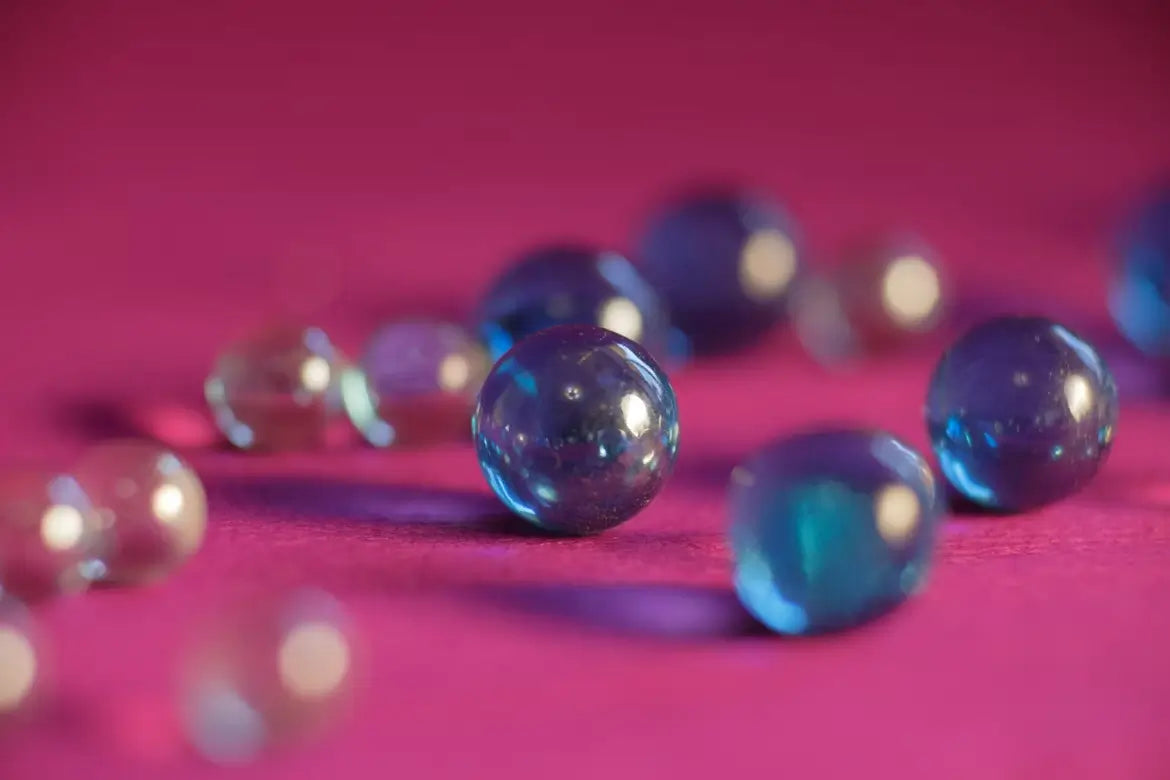 Glass beads used for filling a weighted pillow sitting on a flat surface.