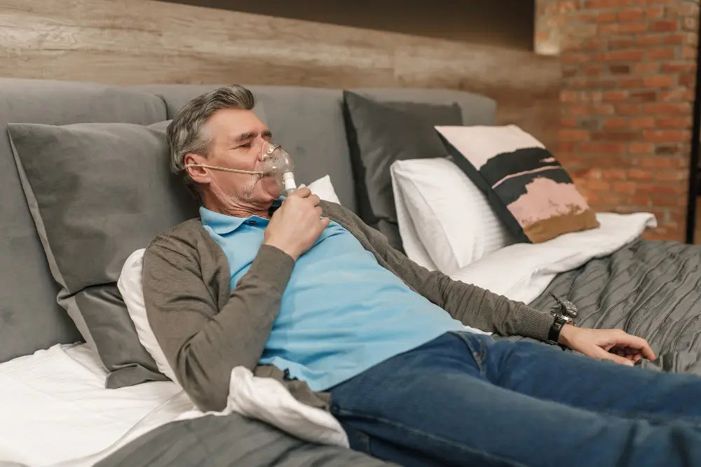 Man lying in bed using an CPAP mask.