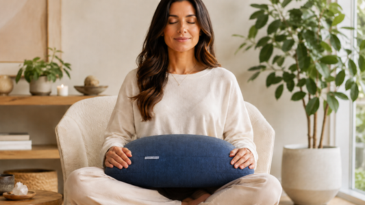 Person resting a lap weighted pillow across their thighs during a calm seated meditation session