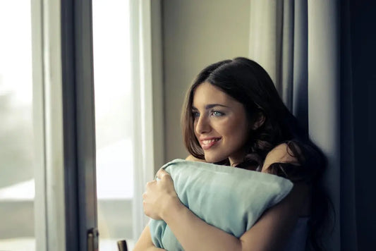 Woman comfortably holding a weighted pillow for calm.