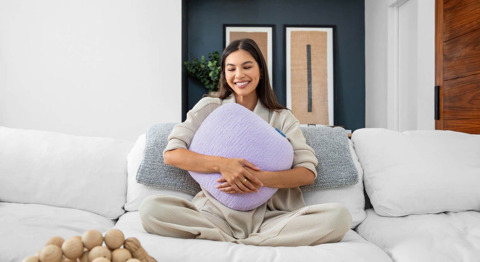 One Quiet Mind weighted pillow held on a white couch during a cozy calm-down moment.
